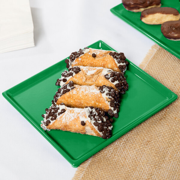 A Tablecraft green cast aluminum rectangular cooling platter with pastries and chocolate chips on it.