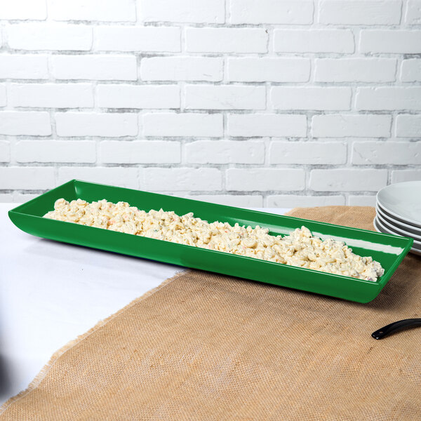 A green rectangular Tablecraft tray with food in it.