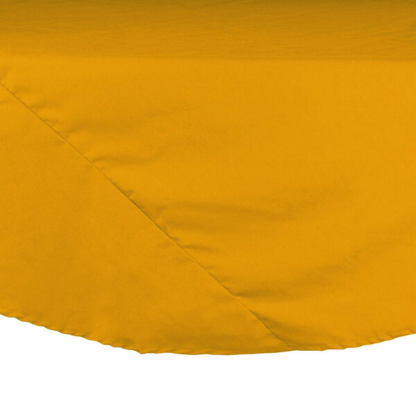A yellow Intedge round tablecloth on a white table.