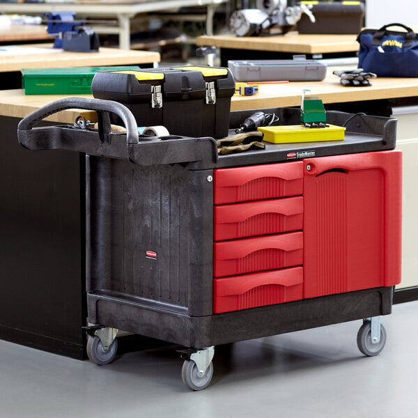 A black Rubbermaid TradeMaster cart with drawers and a cabinet filled with tools.