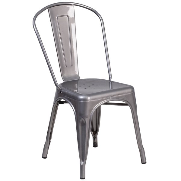 A silver metal Flash Furniture restaurant chair with a vertical slat back and drain hole seat.