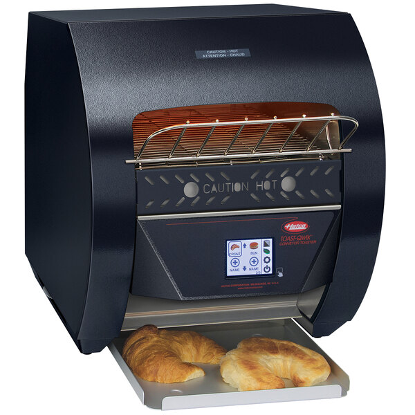 A black Hatco conveyor toaster with bread inside.