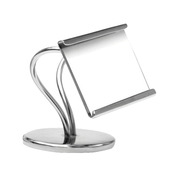 A silver metal Clipper Mill S-shaped card holder on a counter with white paper in it.
