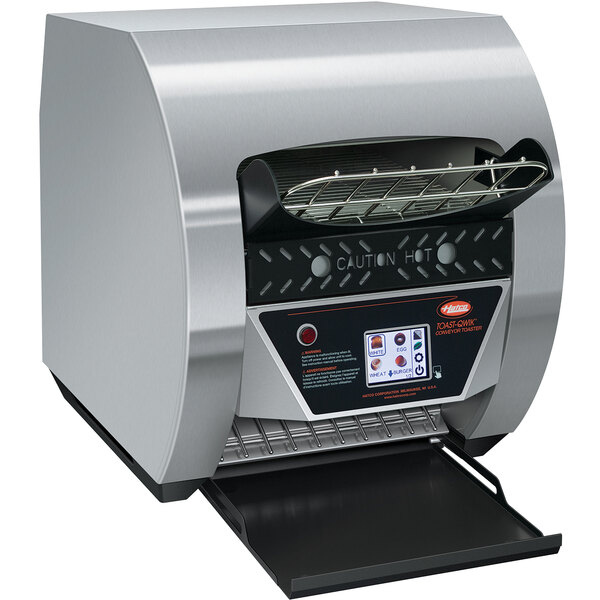 A close-up of a Hatco stainless steel conveyor toaster with digital controls.