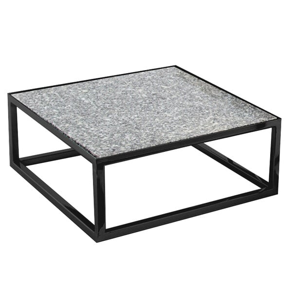 A black powder coated iron square riser with 7 levels on a black and white square table.