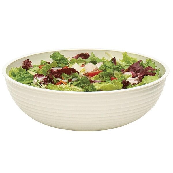 A white Cambro round ribbed bowl filled with salad.