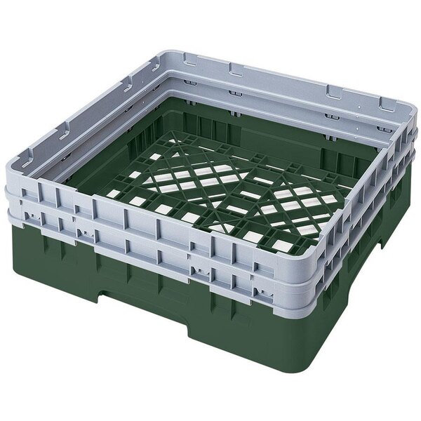 A green plastic Cambro Camrack base rack with closed sides and extenders.