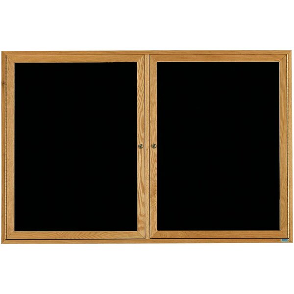 A black Aarco bulletin board with a wooden frame and black glass doors.