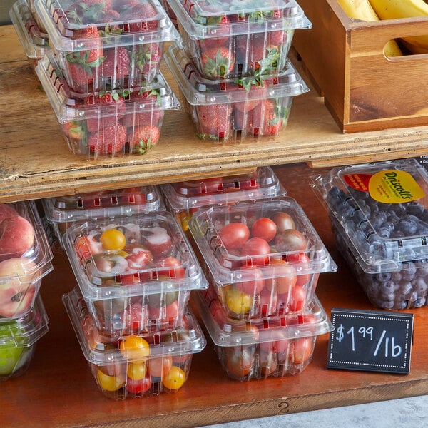 Clear plastic containers of produce on a shelf.