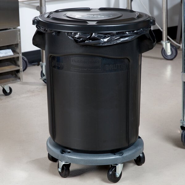 A black Rubbermaid BRUTE trash can on a dolly.