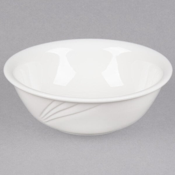 A CAC white porcelain bowl with a curved edge.