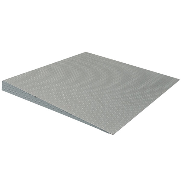 A grey metal access ramp for Tor Rey low-profile industrial floor scales.