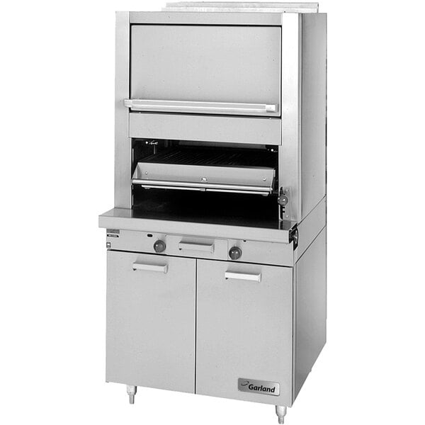 A stainless steel Garland Master Series upright broiler with two open doors.