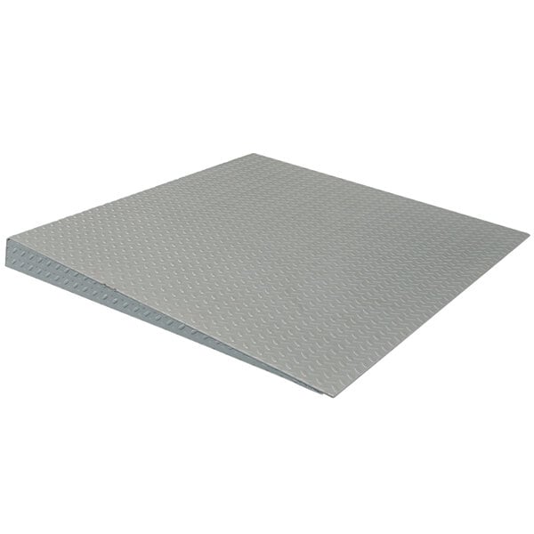 A grey metal Tor Rey access ramp for industrial floor scales.
