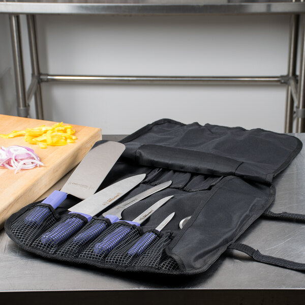 A Dexter-Russell Sani-Safe utility knife set in a mesh bag on a table.