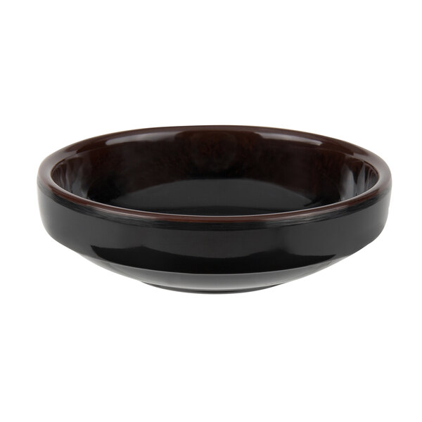 A close-up of a black Thunder Group melamine sauce bowl with a brown rim.
