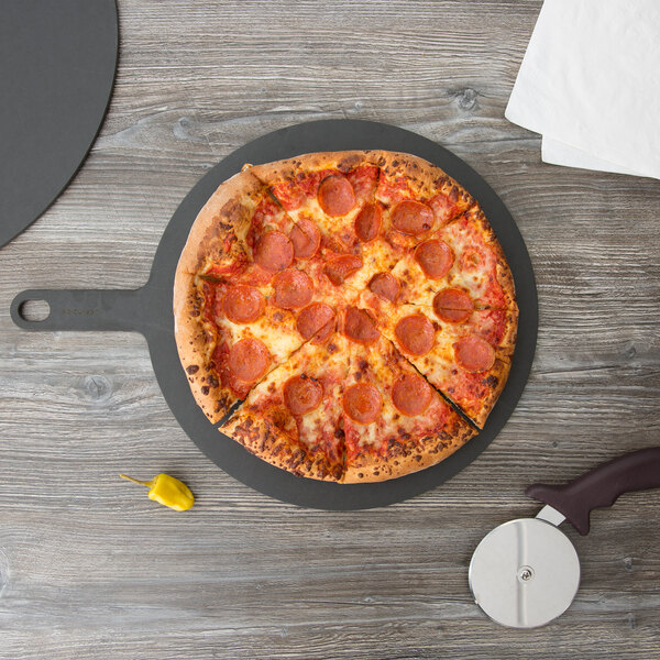 An Epicurean Richlite wood fiber pizza board with a pepperoni pizza on it.