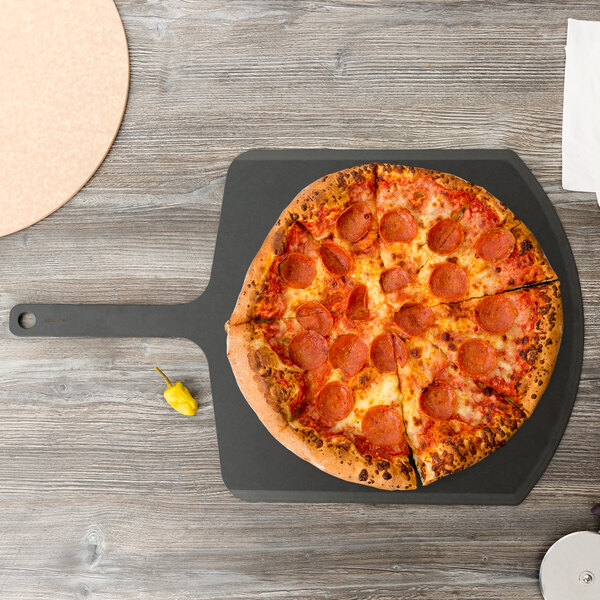 An Epicurean Richlite wood fiber pizza peel with a pepperoni pizza on it.