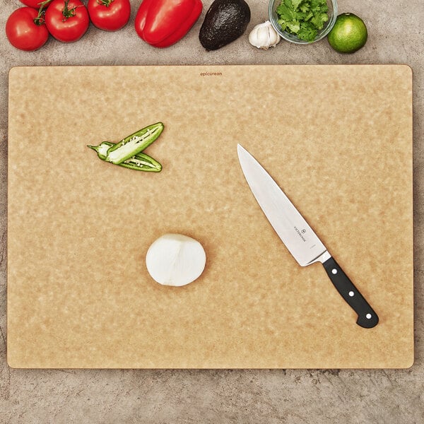 A Big Block Series Epicurean cutting board with vegetables and a knife on a counter.