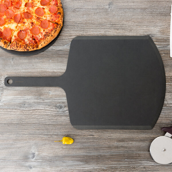 A pepperoni pizza on an Epicurean Richlite pizza peel on a table.
