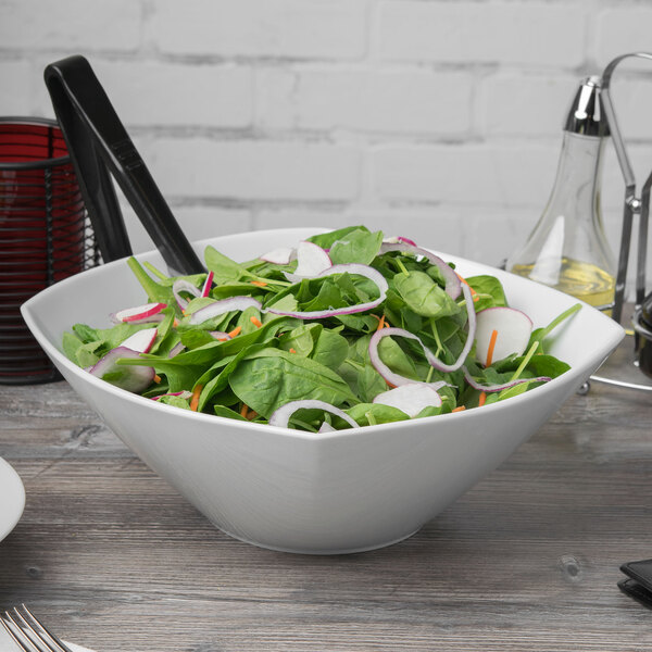 A white Schonwald square porcelain bowl filled with salad.