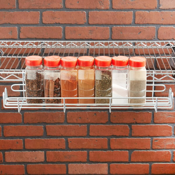 A Metro SmartWall G3 utility shelf holding jars of spices and herbs.