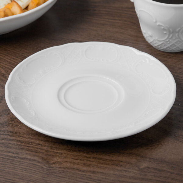 A Schonwald white porcelain saucer on a table.