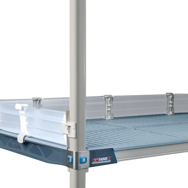 A MetroMax i metal shelf with a clear shelf ledge on a metal table.