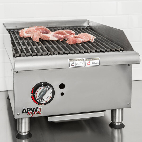 An APW Wyott Workline charbroiler with meat cooking on it.