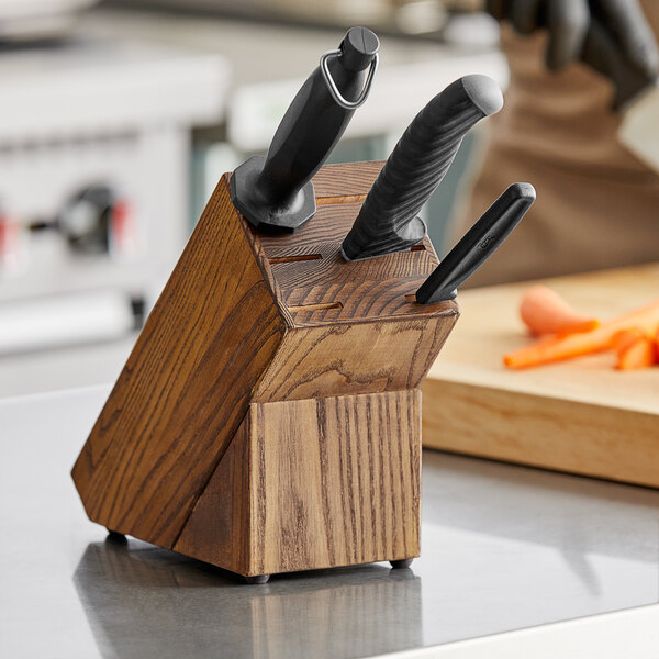A Dexter-Russell wooden knife block holding knives.
