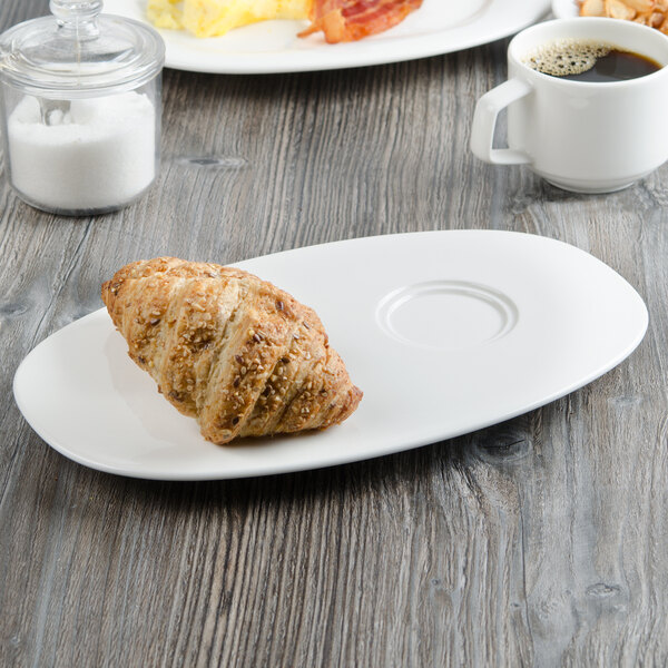 A Villeroy & Boch white porcelain party plate with a croissant and coffee on it.