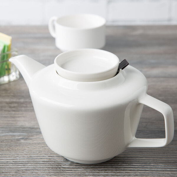 A white Villeroy & Boch porcelain teapot with a lid.
