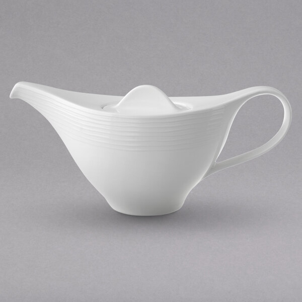 A Villeroy & Boch white porcelain teapot with a handle.