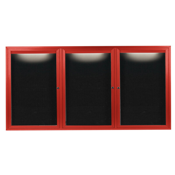 A red cabinet with three black doors and a black letter board inside.