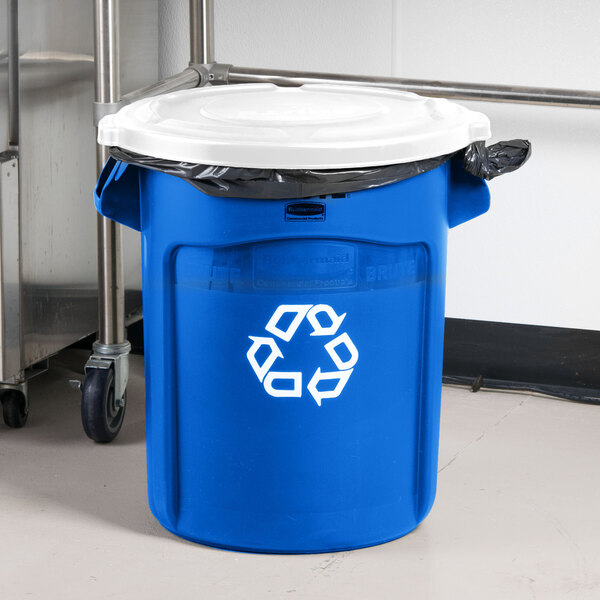 A blue Rubbermaid recycling can with a white lid.