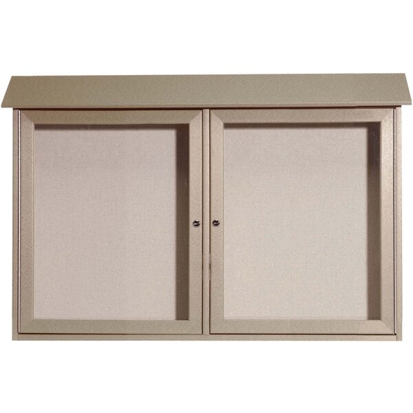 A white cabinet with two doors open and a white board with a metal frame inside.