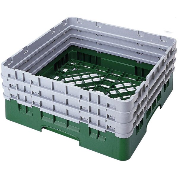A stack of green and grey plastic Cambro dish racks with closed sides.
