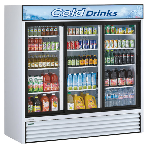 A white Turbo Air merchandising cooler with drinks behind glass doors.