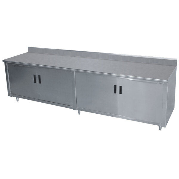 A stainless steel Advance Tabco enclosed base work table with hinged doors.