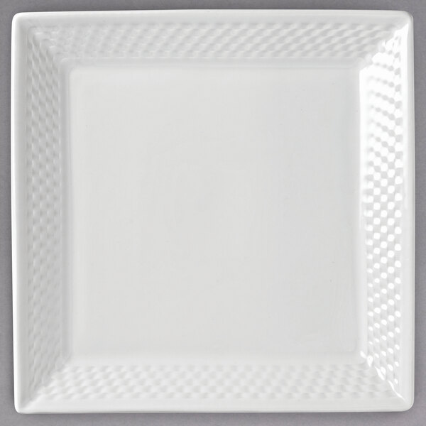 A white square Libbey porcelain plate with a textured pattern of squares.