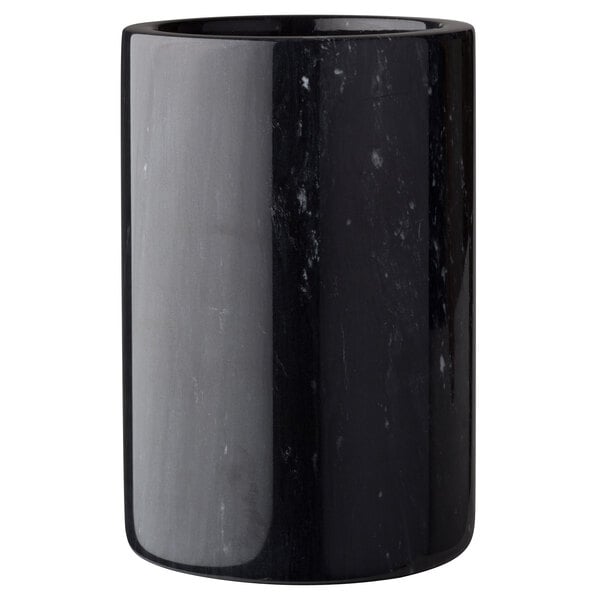 A close-up of a black marble wine cooler with white specks.