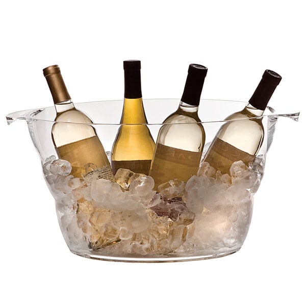 A group of bottles of wine in a Franmara clear acrylic oval cooler full of ice.