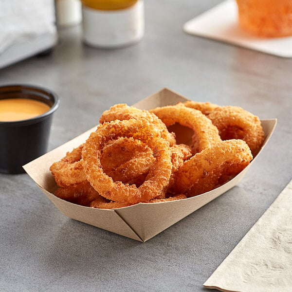A Bagcraft Packaging EcoCraft paper food tray filled with fried onion rings with a side of dipping sauce.