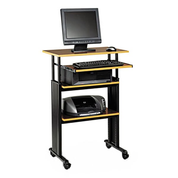 A Safco cherry and black adjustable height stand-up computer workstation with a computer and printer on it.
