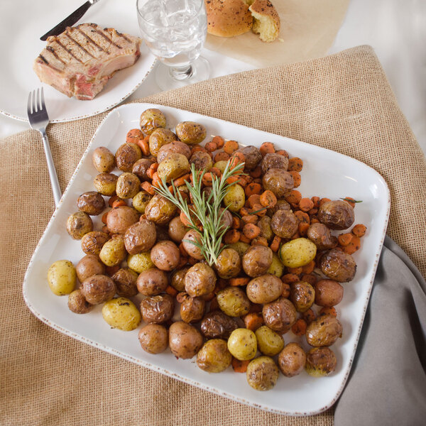 A GET Urban Mill rectangular melamine platter with roasted potatoes and carrots on a table.