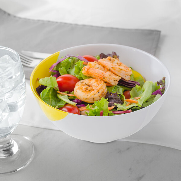 A white melamine bowl filled with salad, shrimp, and tomatoes.