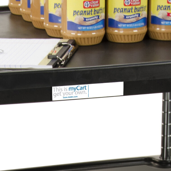 A shelf with a group of personalized utility cart labels on jars of peanut butter.