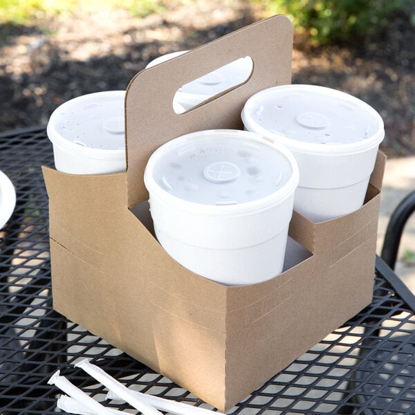 A brown Kraft container holding four white plastic cups.