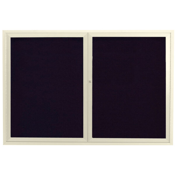 A black rectangular directory board with two white framed doors.