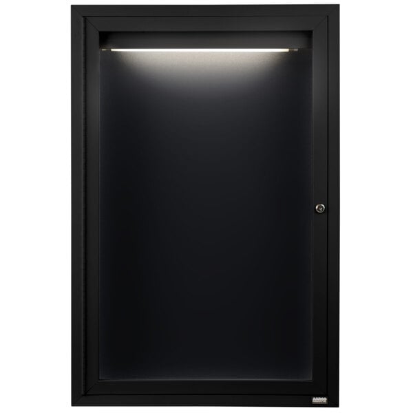 A black cabinet with a light on a door.